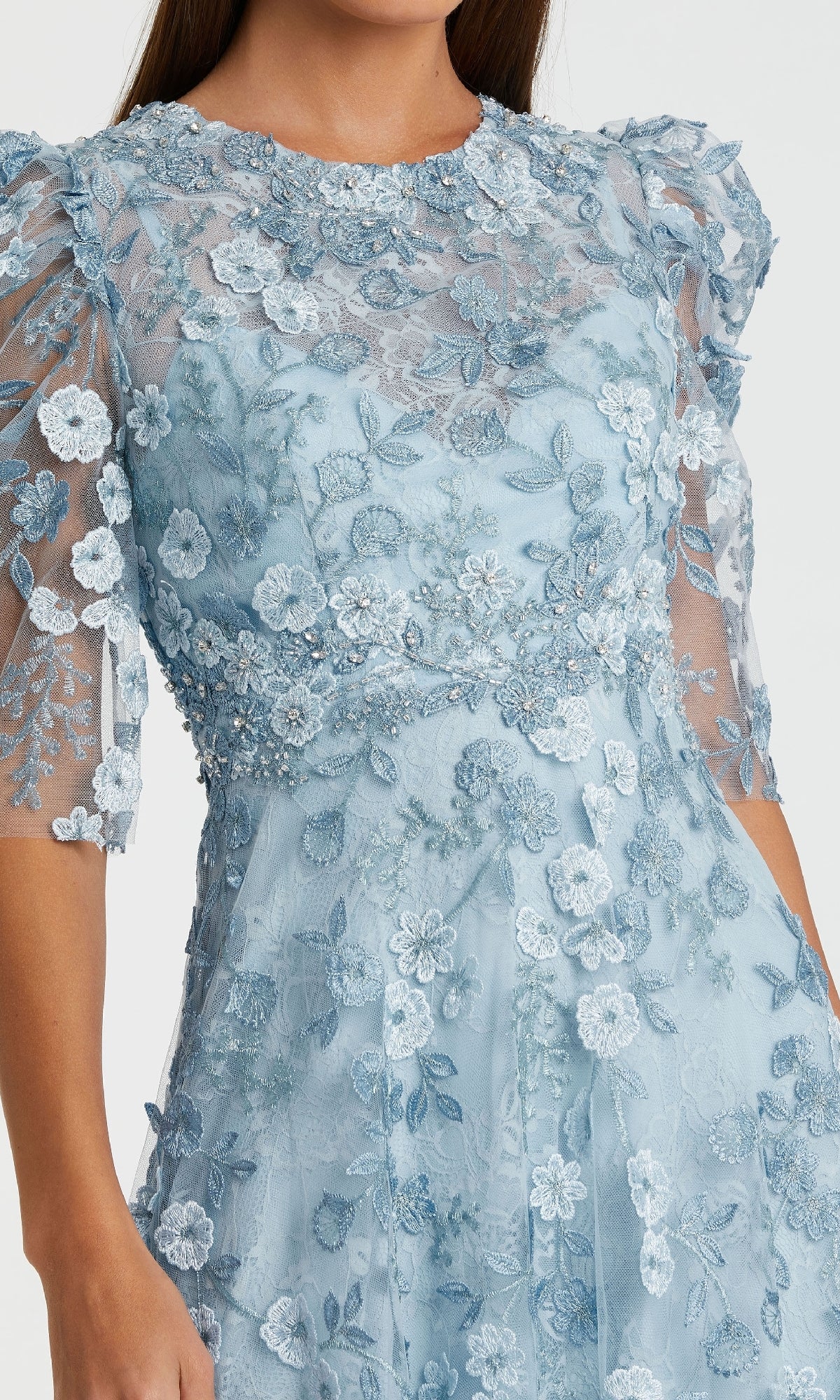 A woman wearing the Mac Duggal 68193 Tea-Length Lace Formal Dress in light blue with floral embroidery and sheer puff sleeves.